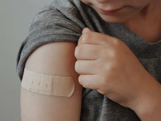 photo of vaccinated boy showing arm after covid19 vaccine injection picture id1313998982