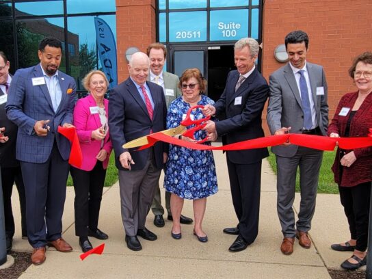 photo of officials celebrating ribbon cutting for RADA USA expansion