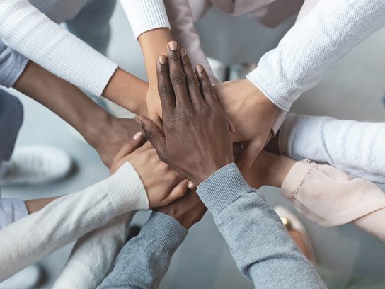 photo of hands joining together