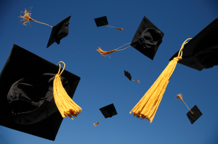 Graduation Caps thrown in sky photo