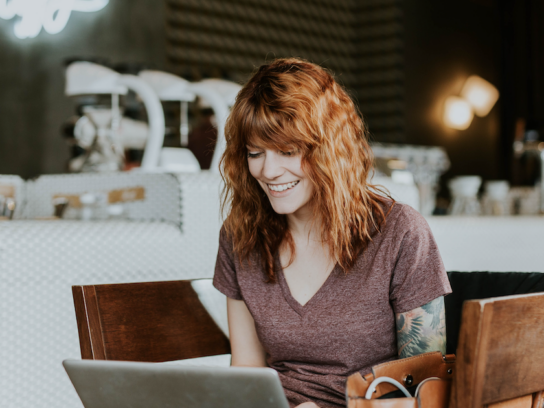 photo of woman looking at her laptop