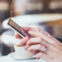 photo of woman hands holding smartphone in cafe picture-id875258198