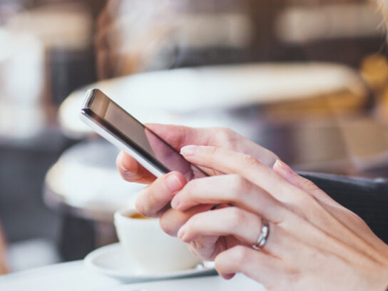 photo of woman hands holding smartphone in cafe picture-id875258198