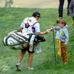 photo of 2022 Wells Fargo golfer signing child's autograph