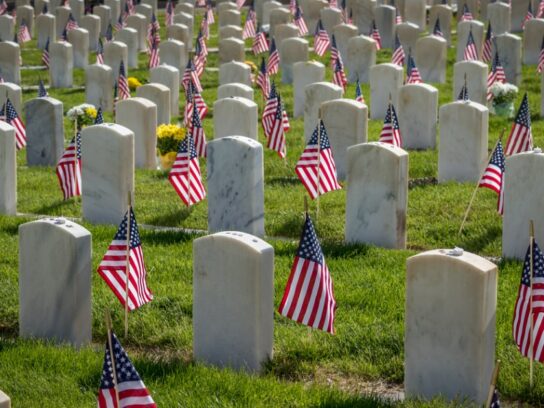 photo of military grave markers with flags for memorial day