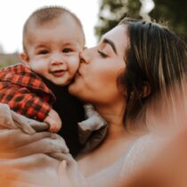 photo of woman holding a small child