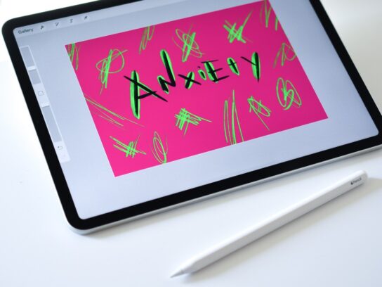 photo of the word anxiety written on a computer pad