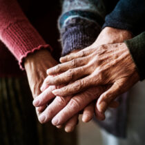photo of closeup of hands of group of seniors