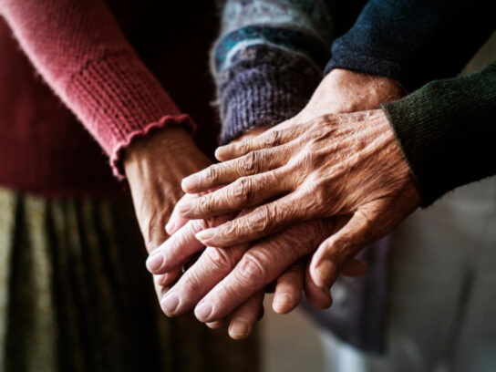 photo of closeup of hands of group of seniors