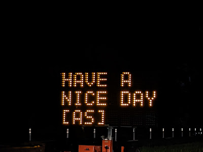 An electronic sign board that has been digitally hacked to read "Have A Nice Day [AS]."