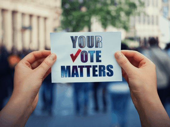 photo of hands holding sign that reads Your Vote Matters