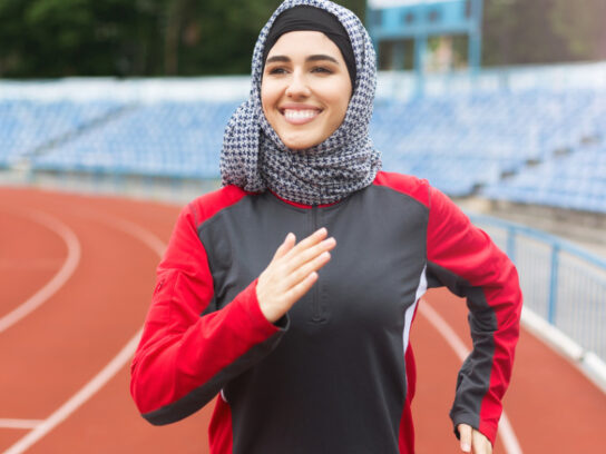 photo of muslim woman with hajib running tract