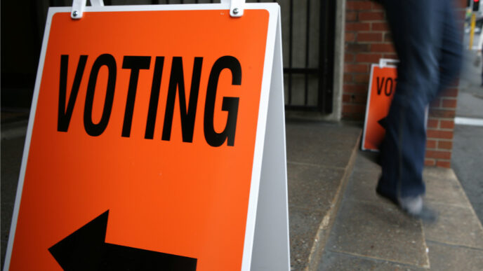 photo of person walking out of polling place on election day