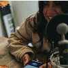 photo of woman recording a podcast