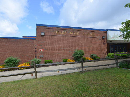 The front entrance with the school name on the building. Fields Road Elementary School is part of the Montgomery County Public School system. 1 School Drive, Gaithersburg, Maryland.