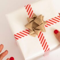 photo of hand holding wrapped gift