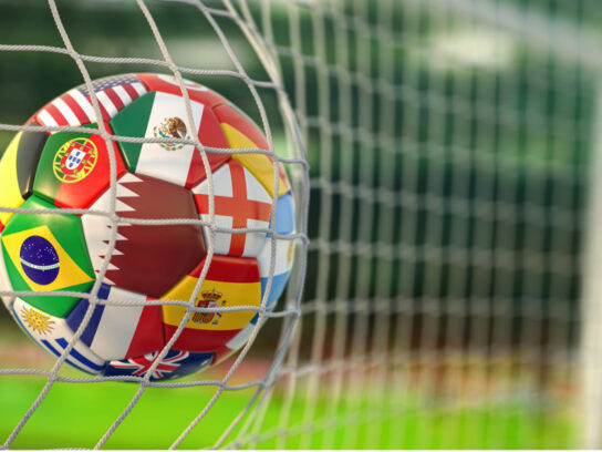 photo of soccer ball in net world cup