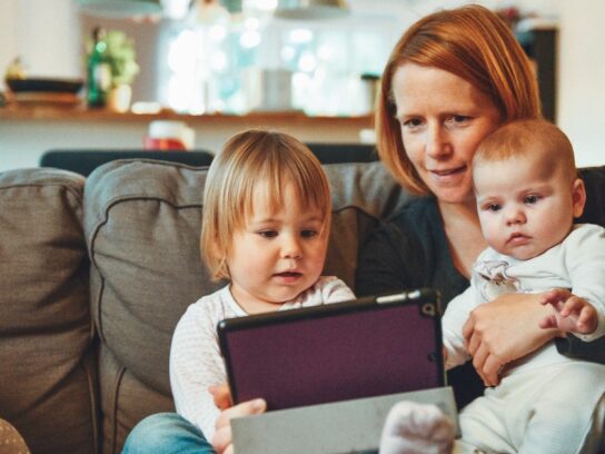 photo of mother with two children in her lap