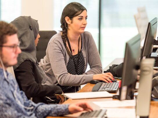 young adults working at computers together