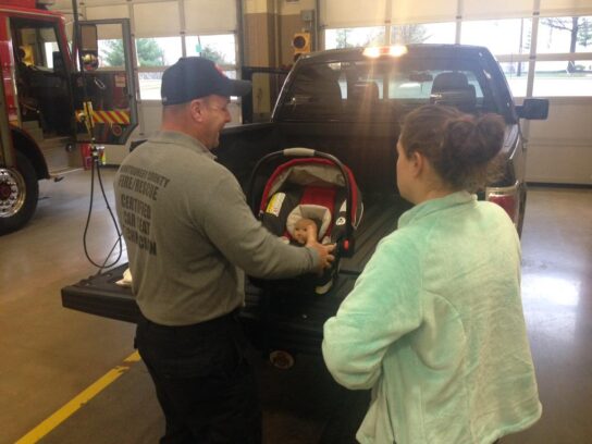 photo of mcfrs helping with infant car seat