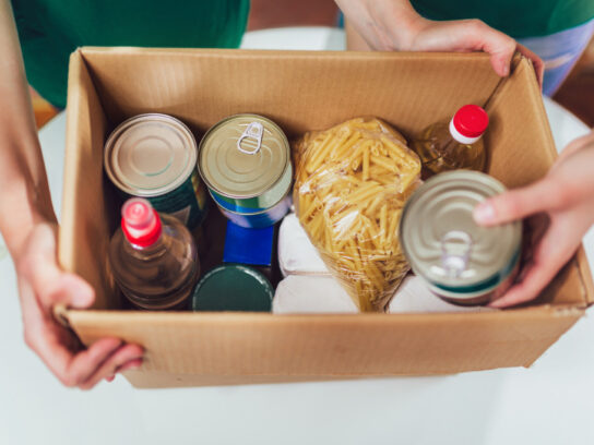 box of canned non-perishable food for donation istock
