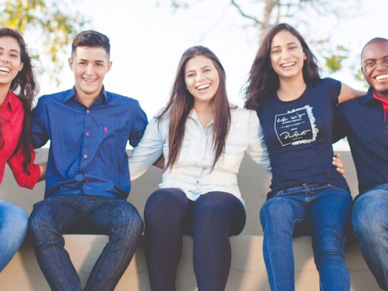 photo of diverse young adults sitting on a sofa