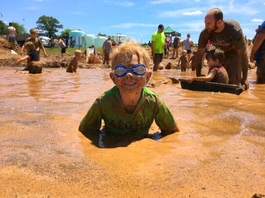 photo of boy enjoying mudfest event