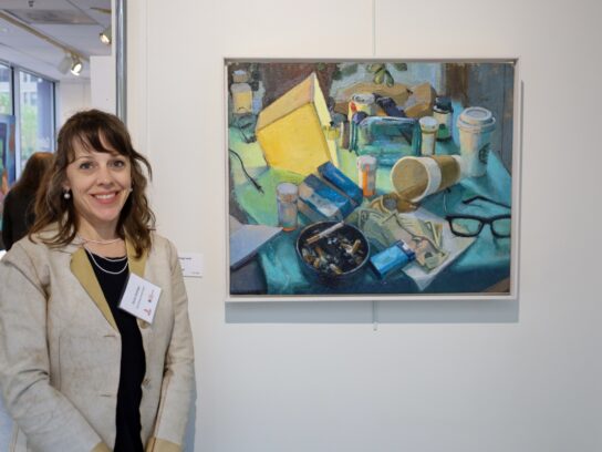 Artist Nicole Santiago at Bethesda Painting Awards with her winning painting