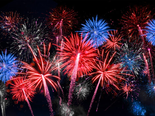 photo of red white and blue fireworks in night sky