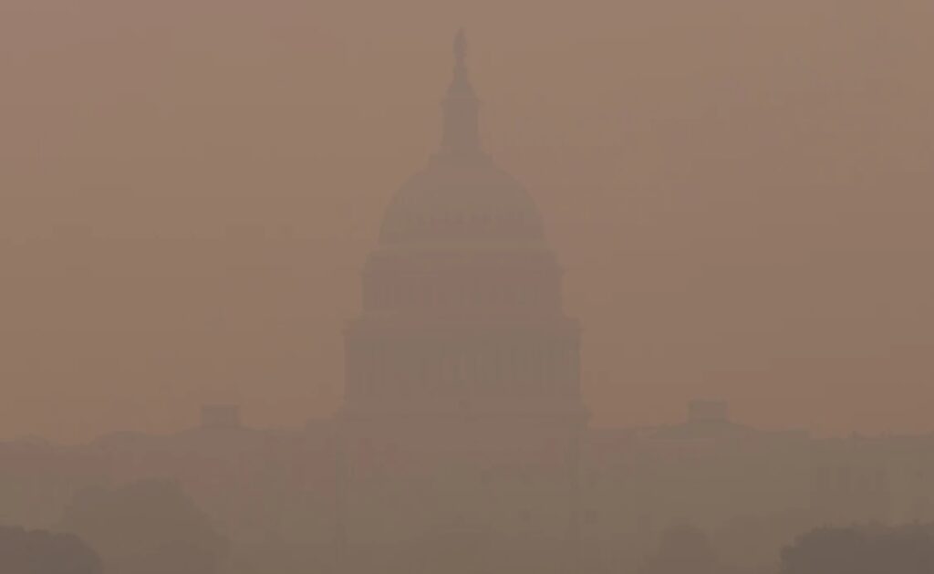 The US Capitol almost invisible in smoke from Canadian wildfires, 2023.