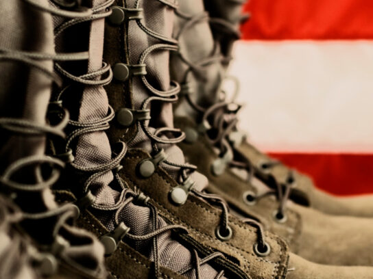 photo of combat boots in front of american flag