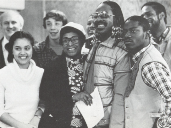"Stevie Wonder poses with staff and students after impromptu performance at Montgomery Blair High School, Jan. 14, 1981." Via. Blair 1981 yearbook.